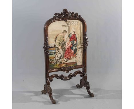 A VICTORIAN ROSEWOOD AND NEEDLEWORK FIRESCREEN, with scroll and foliate carved crest, raised on a trestle base with leaf carv