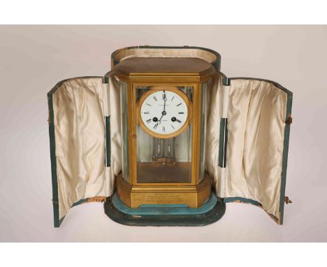 A GILT BRASS FOUR-GLASS MANTEL CLOCK, SIGNED EDWARD & SONS, GLASGOW, with bowed sides and bevelled glass, Japy Freres two-tra