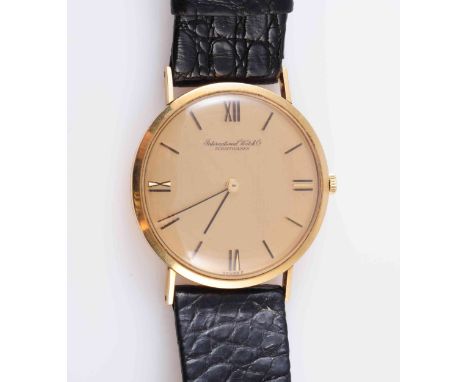 INTERNATIONAL WATCH COMPANY, A GENTLEMAN'S 18 CARAT GOLD SLIM CASED WRISTWATCH, circular dial with baton markers, leathers st