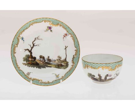 A MEISSEN CABINET CUP AND SAUCER, the cup painted with a shooting vignette, the saucer painted with deer in a landscape, embe