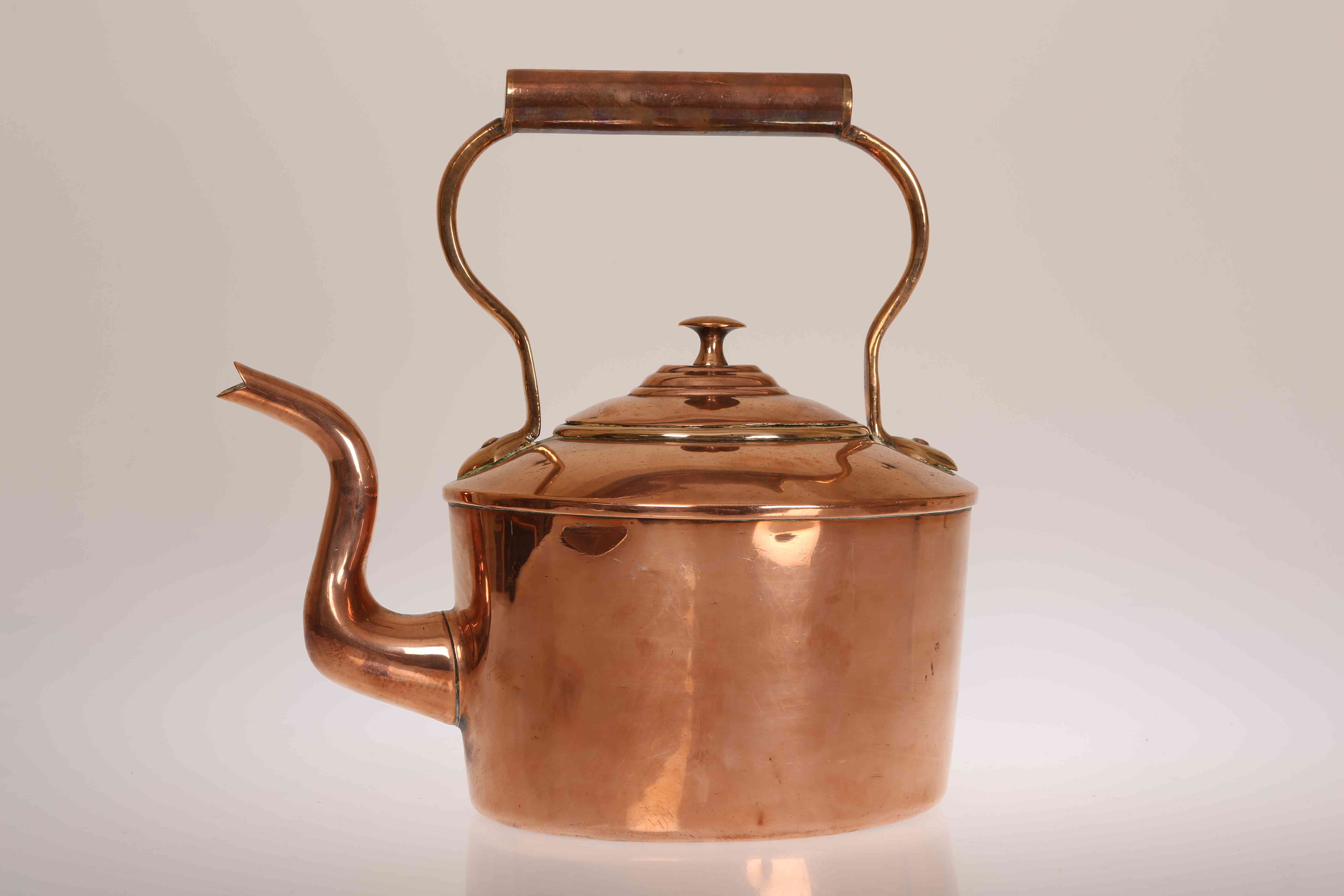 A 19TH CENTURY POLISHED COPPER KETTLE, with maker's mark. 28cm high