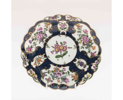 A DR WALL WORCESTER CABINET PLATE, CIRCA 1775, with scalloped rim, painted with shaped cartouches containing flowers, against