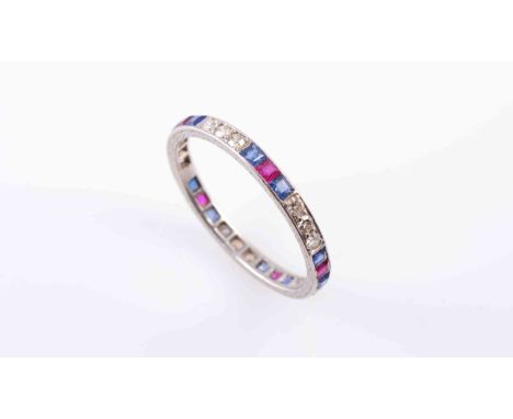 A SAPPHIRE, RUBY AND DIAMOND ETERNITY RING, the five sets of three brilliant cut diamond highlights alternately and evenly sp