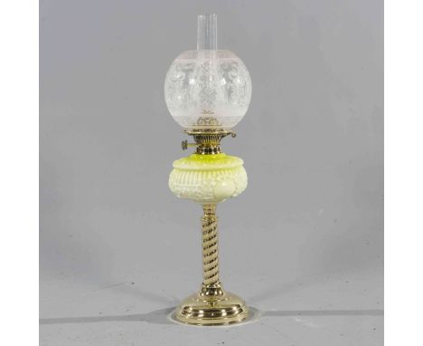 A VICTORIAN BRASS AND CASED GLASS OIL LAMP, with twisted brass stem and tinted green glass reservoir. 66cm