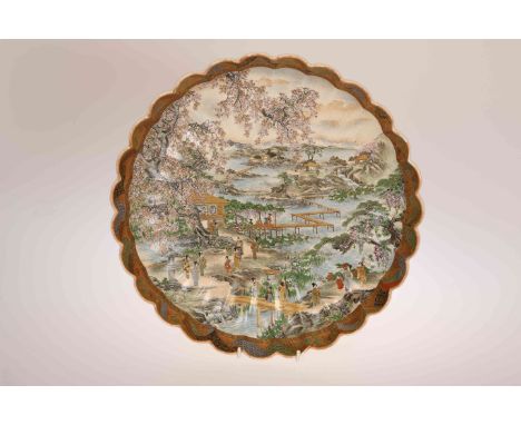A JAPANESE SATSUMA SCALLOPED DISH, Meiji period (1868-1912), signed Yokohama Hodota to three reserves with black and red grou