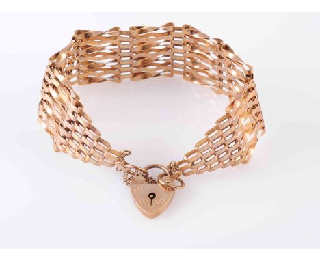 A GOLD GATE LINK BRACELET, circa 1900, with heart padlock clasp and safety chain. Stamped 375. Weight 14.2gms. 