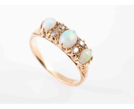 A LATE VICTORIAN OPAL AND DIAMOND RING, CIRCA 1890, set with three oval cabochon-cut opals, spaced by pairs of old brilliant-