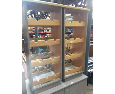 A PAIR OF LIGHT WOOD AND PAINTED BOTTLE RACKS