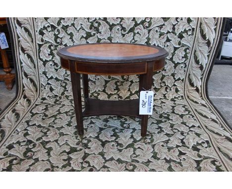 Mahogany and rosewood oval table with shelf stretcher on square tapering legs terminating in castors 700mm x 450mm x 600mm