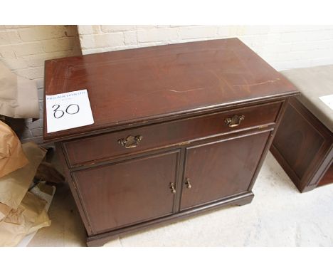 Mahogany two door cabinet on plinth base panelled doors below a drop down drawer internally fitted with drawers and pull out 