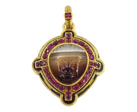 19th gold locket pendant, carved agate mask face, with ruby and black enamel surround, the reverse with hinged hardstone comp