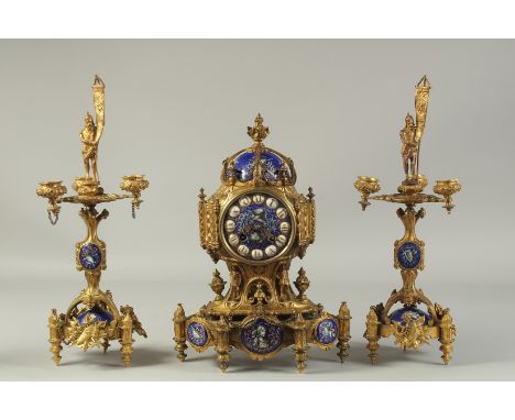A VERY GOOD 19TH CENTURY FRENCH GILT METAL AND BLUE ENAMEL THREE PIECE CLOCK GARNITURE, the clock with enamel face and vignet