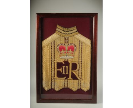AN E. R. ROYAL COACHMAN'S TUNIC in a glass case. 26ins x 16ins.