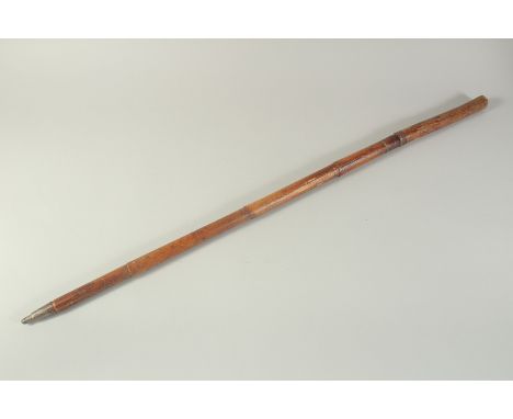 AN EARLY WOODEN CASED SWORD STICK with engraved blade. 3ft long.
