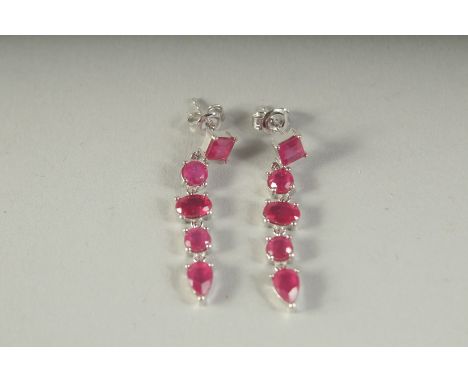 A PAIR OF SILVER RUBY SET LONG DROP EARRINGS, boxed.