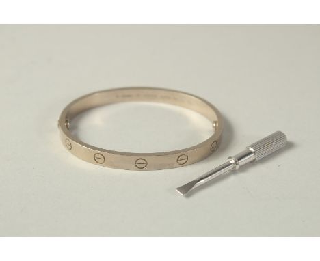 AN 18CT WHITE GOLD CARTIER BANGLE with screwdriver, No.  GSD 066 AU 750. 6cm x 5cm, weight 39.5 gms including screw, in a red