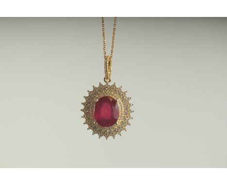 A SILVER RUBY SET GOLD PLATED PENDANT AND CHAIN, boxed.