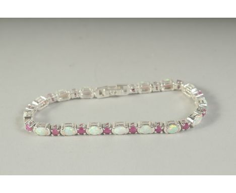 A SILVER OPAL AND RUBY LINE BRACELET, boxed.