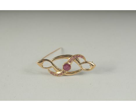 A 9CT GOLD RUBY SET BROOCH, boxed.