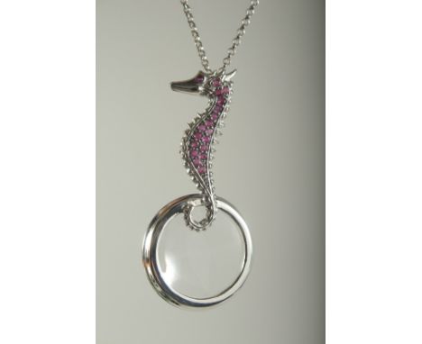 A SILVER RUBY SET SEAHORSE SPYGLASS ON A CHAIN.