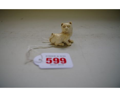A Japanese carved ivory netsuke of a cat, Meiji period, signed, 4cm wide. 