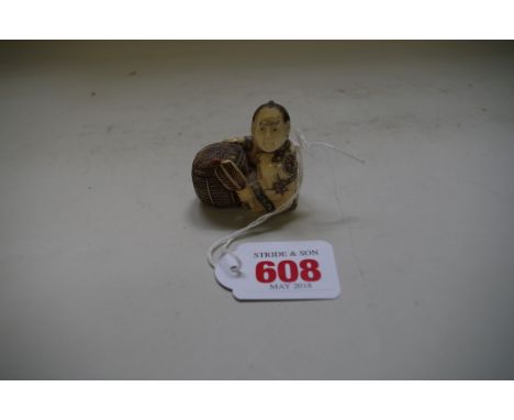A Japanese carved bone netsuke of a man with a wicker basket, signed, 4.4cm high. 