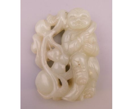 A celadon jade pendant formed as a boy. 6 cm high.