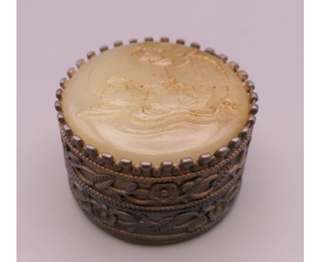 A jade topped pill box. 4 cm diameter.