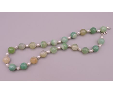 A pearl and jade necklace.  Approximately 44 cm long. 