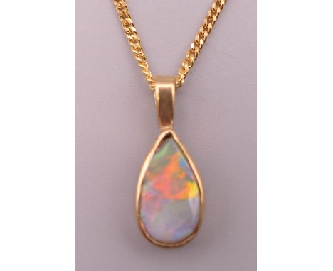 An opal and gold pendant on 9 ct gold chain.  Pendant 2 cm high including suspension loop, chain 46 cm long. 4.5 grammes tota