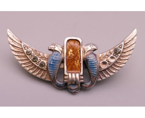 A winged enamel brooch.  4.25 cm wide.