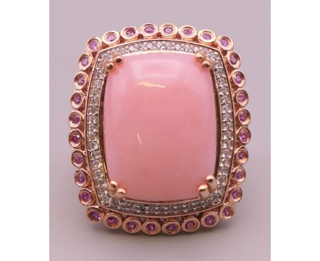 A silver, pink stone and cubic zirconia ring.  Ring size Q/R.