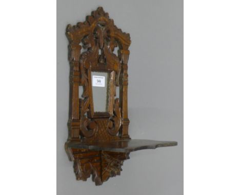A Victorian carved mirrored wall bracket. 36 cm high.