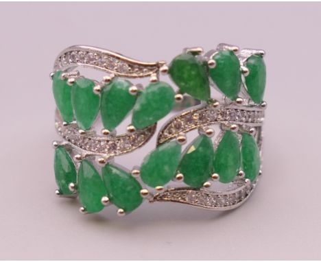 A silver, green stone and cubic zirconia ring.  Ring size R/S.