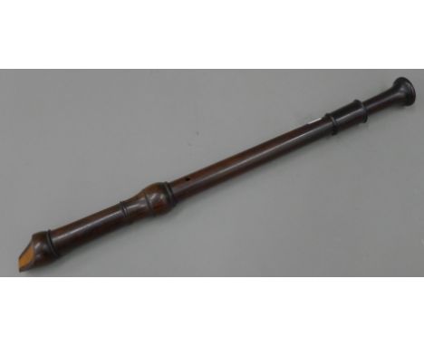 A rosewood recorder by Schott's of England. 61.5 cm long.