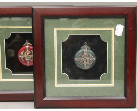 A pair of framed Chinese jade pendants. 24 x 24 cm overall.