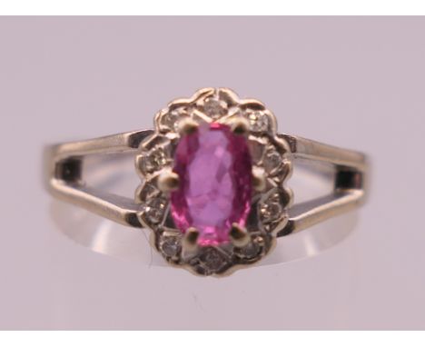 An 18 ct white gold, Burmese ruby and diamond ring.  Ring size O/P. 4.7 grammes total weight.
