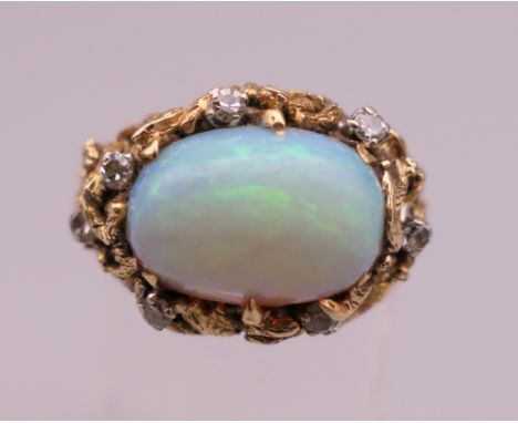 A vintage 14 K gold, diamond and cabochon cut opal ring. The opal approximately 4 ct.  Ring size R/S. 10.6 grammes total weig