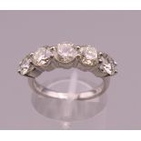 A platinum five stone diamond ring. Approximately 2.65 total carat weight. Ring size M.