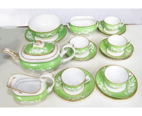 A DERBY MOULDED APPLE GREEN GROUND TEA SERVICE, THE SERVICE INCLUDING A SILVER SHAPED TEAPOT AND COVER AND CREAM JUG, RED PAI