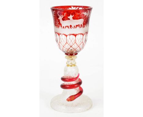 A BOHEMIAN RUBY FLASHED AND WHEEL ENGRAVED GLASS GOBLET, THE BELL SHAPED FOOT APPLIED WITH A COILED SERPENT, 32CM H, MID 19TH