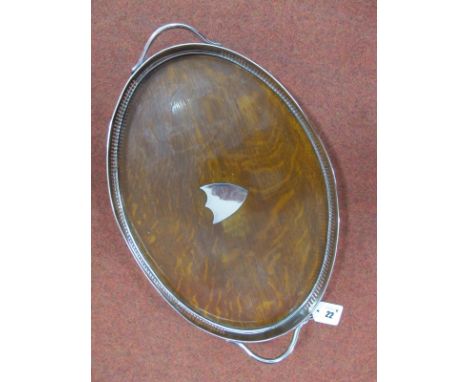 A c.Early XX Century Plated Mounted Twin Handled Oval Tray, the oak base with applied shield (vacant), overall width over han