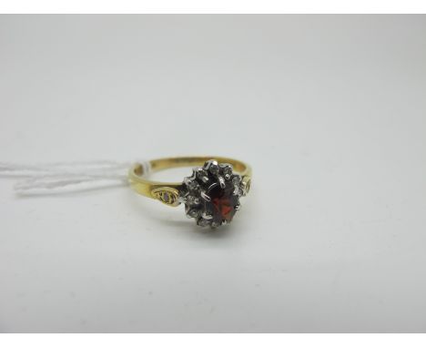 An 18ct Gold Cluster Dress Ring, claw set between inset shoulders (finger size L1/2) (2.5grams). 