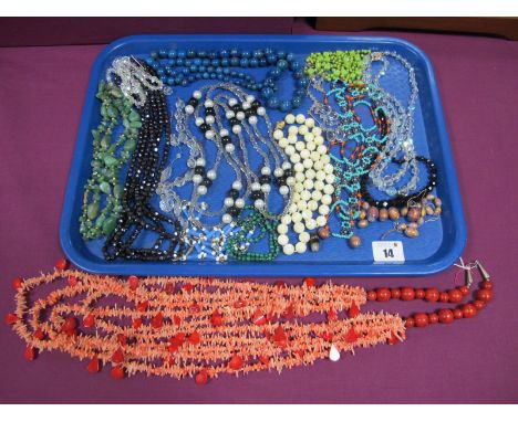 A Long Graduated Multi Strand Coral Necklace, together with a single strand mother of pearl bead necklace, vintage faceted be