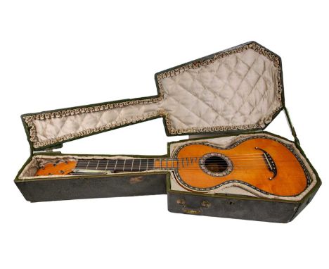 An early 19th century French classical guitar, stamped 'M.C. Mousset à Paris' to the inside, the back and sides of bird's eye