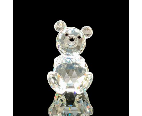 A clear crystal figure of a bear sitting on his bottom with their four paws facing forward with black crystal used for the ey