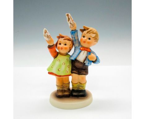Boy and girl waving are colored in green, red, blue and brown. Hummel impressed in base. Goebel backstamp. Issued: 1979 - 199