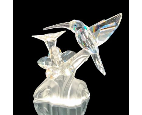 Depicts a clear blue-eyed hummingbird and two crystal flowers on top of a fogged crystal plant. Swarovski backstamp. This ite