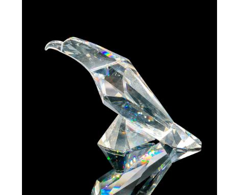 Depicts a clear eagle with its wings closed, resting on its feet. Swarovski backstamp. This item has its original box. Dimens