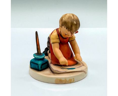 Hand painted figure of a young boy writing a letter on a large piece of paper. Goebel Hummel backstamp. HUM 309. Issued: c. 1